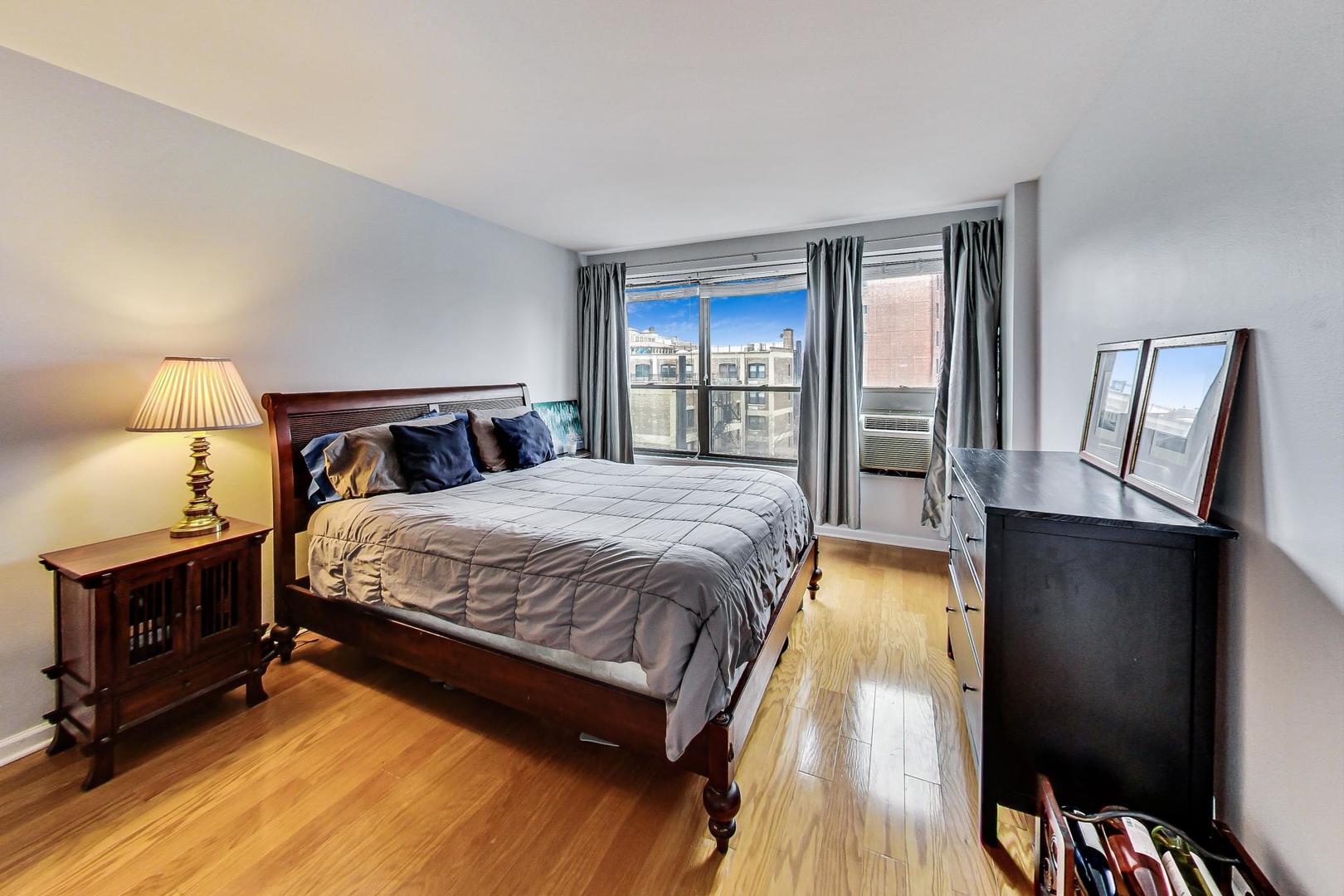 2930 North Sheridan Road, Unit 802 Chicago, IL 60657 - Photo 13 of 30 a spacious bedroom with a bed and wooden floor
