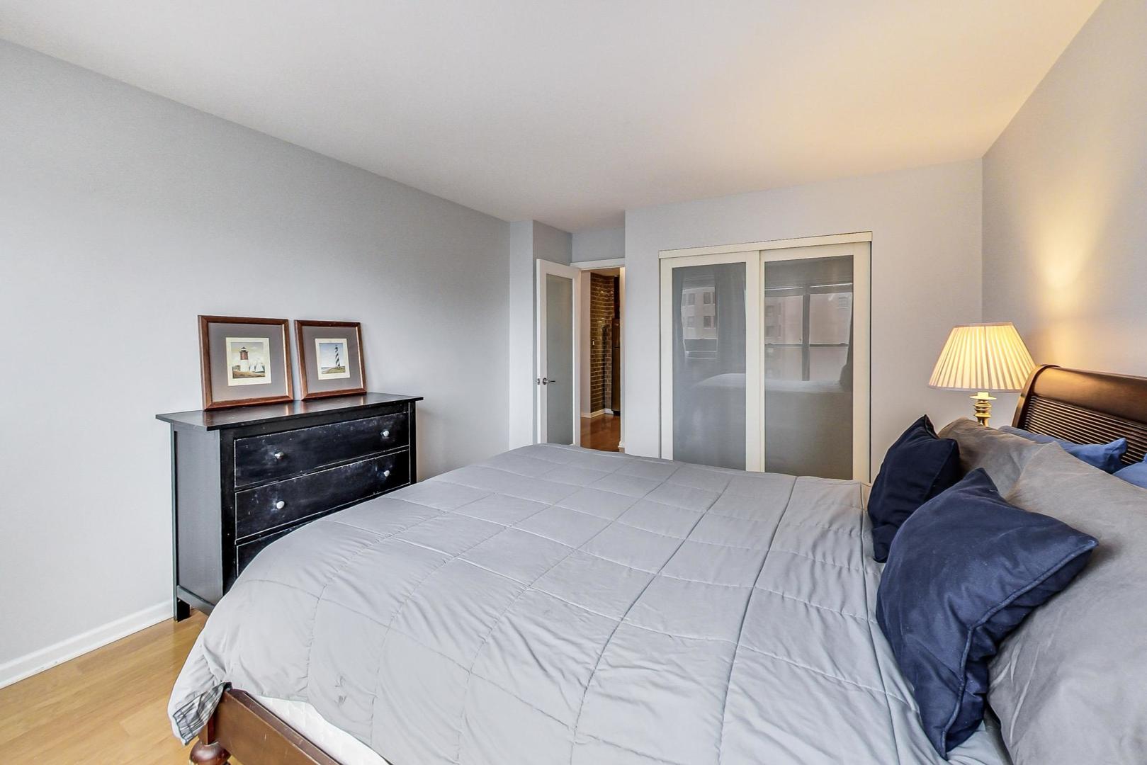 2930 North Sheridan Road, Unit 802 Chicago, IL 60657 - Photo 15 of 30 a bedroom with a bed and wooden floor