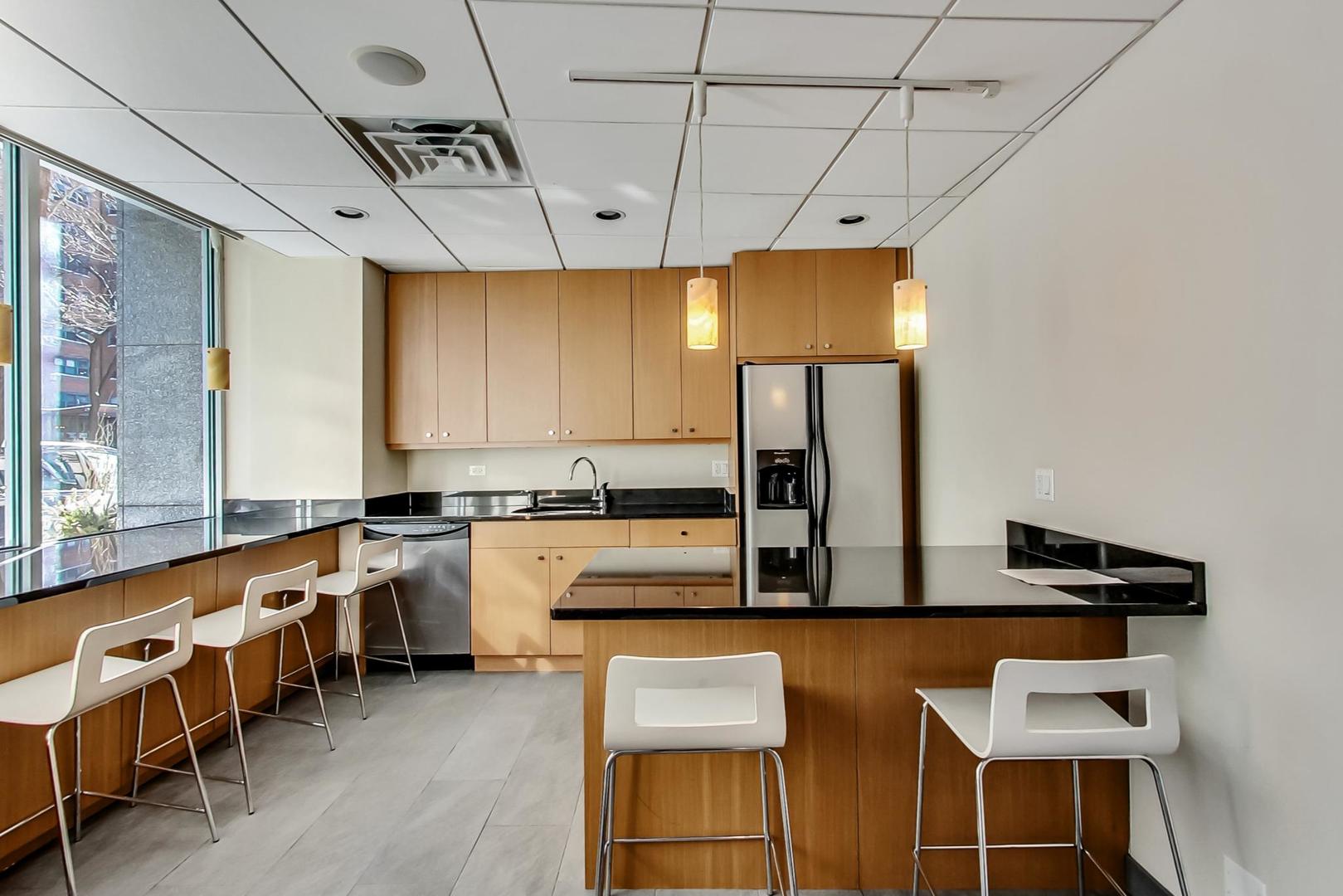 2930 North Sheridan Road, Unit 802 Chicago, IL 60657 - Photo 29 of 30 a kitchen with lots of counter space and appliances