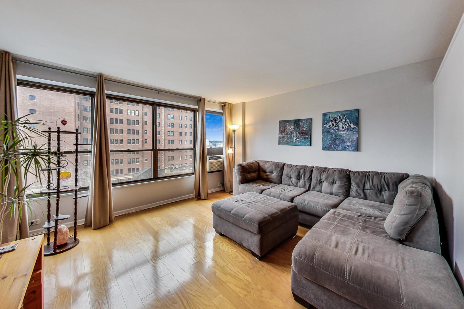 2930 North Sheridan Road, Unit 802 Chicago, IL 60657 - Photo 4 of 30 a living room with furniture and a flat screen tv