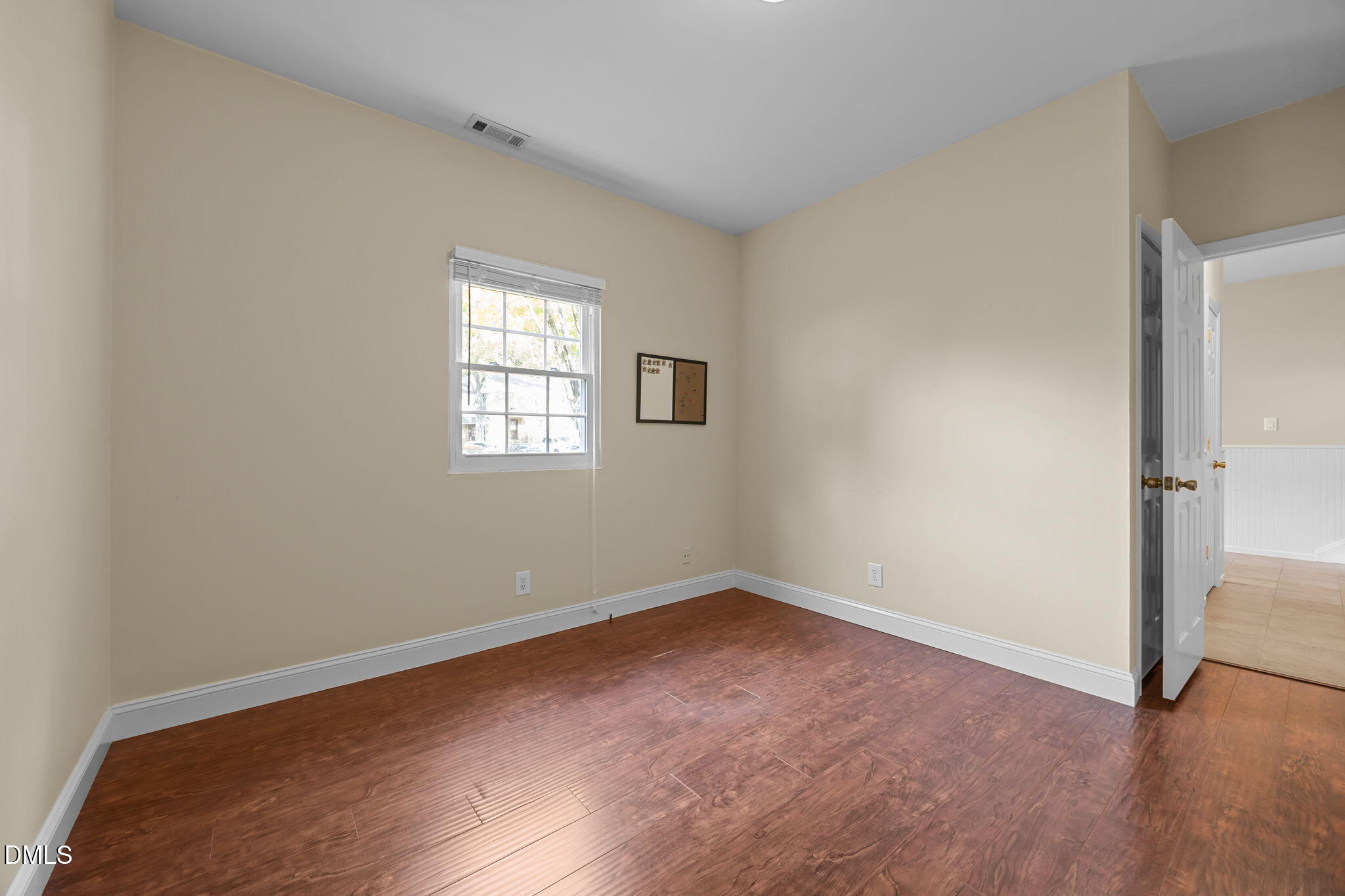 6423 New Market Way Raleigh, NC 27615 - Photo 19 of 33 an empty room with wooden floor and windows