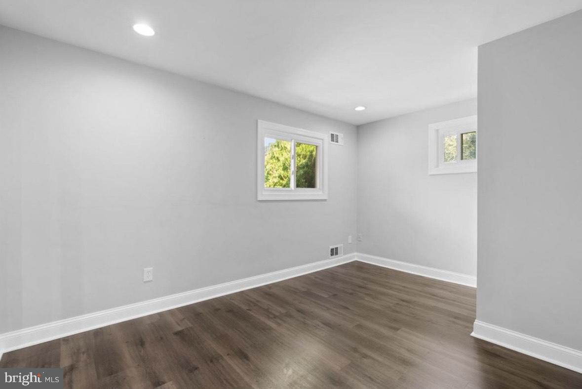 9802 Cherry Tree Lane Silver Spring, MD 20901 - Photo 14 of 33 an empty room with wooden floor and window