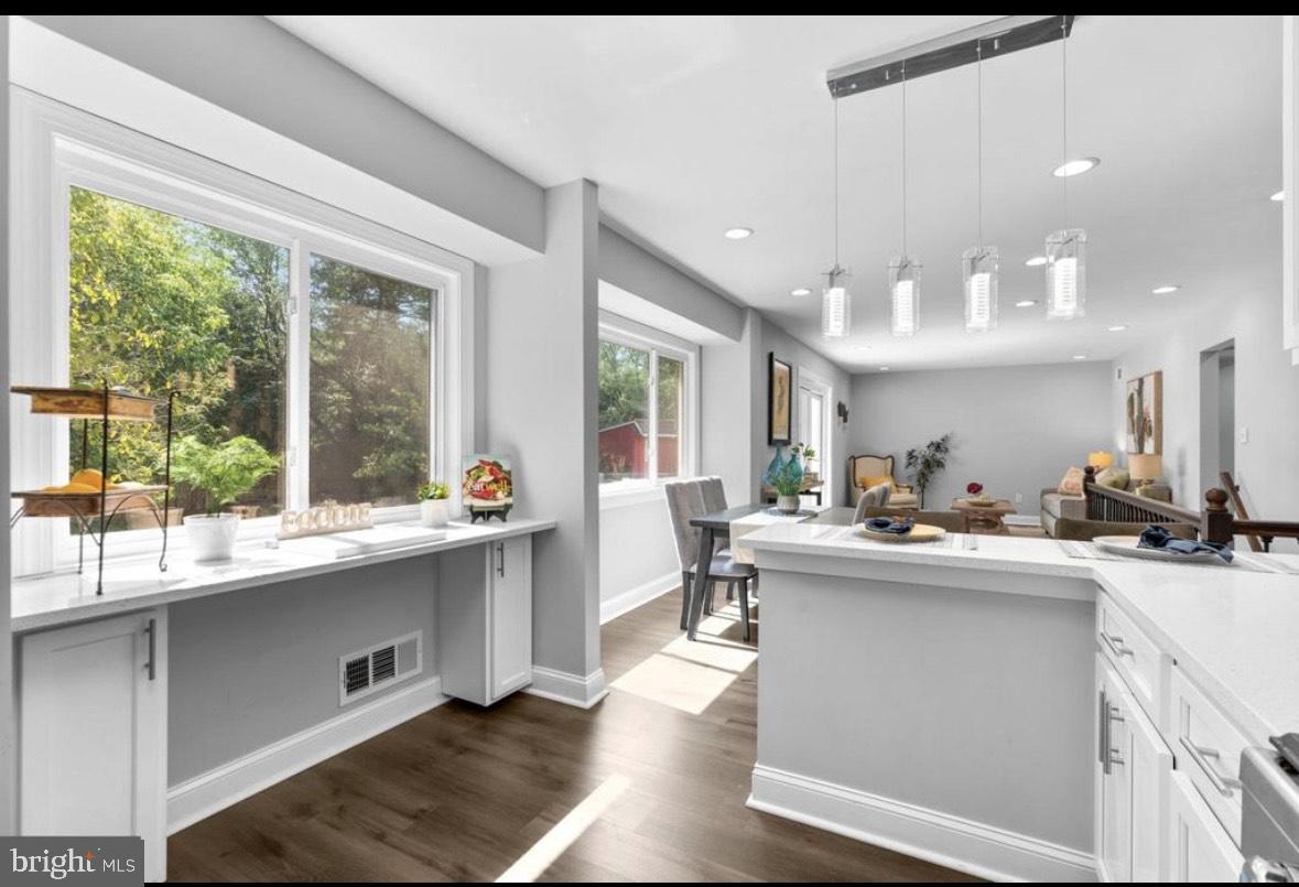 9802 Cherry Tree Lane Silver Spring, MD 20901 - Photo 15 of 33 a kitchen with counter top space a sink appliances and cabinets