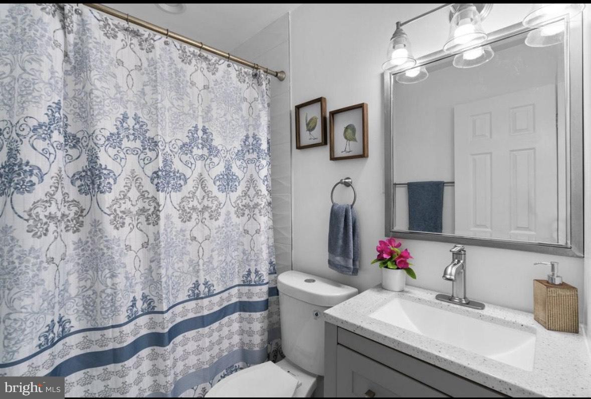 9802 Cherry Tree Lane Silver Spring, MD 20901 - Photo 16 of 33 a bathroom with a sink toilet and shower