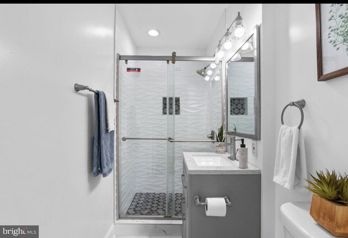 9802 Cherry Tree Lane Silver Spring, MD 20901 - Photo 18 of 33 a bathroom with a sink and a mirror