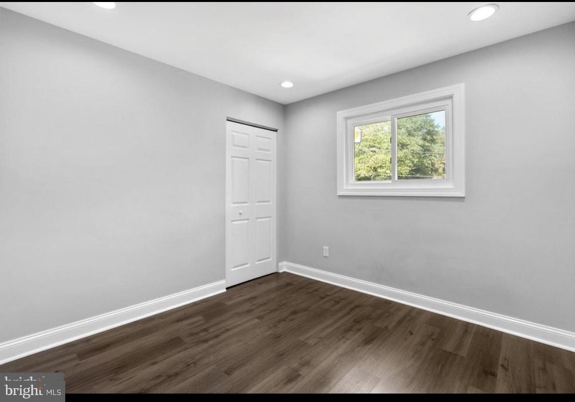 9802 Cherry Tree Lane Silver Spring, MD 20901 - Photo 19 of 33 an empty room with wooden floor and windows