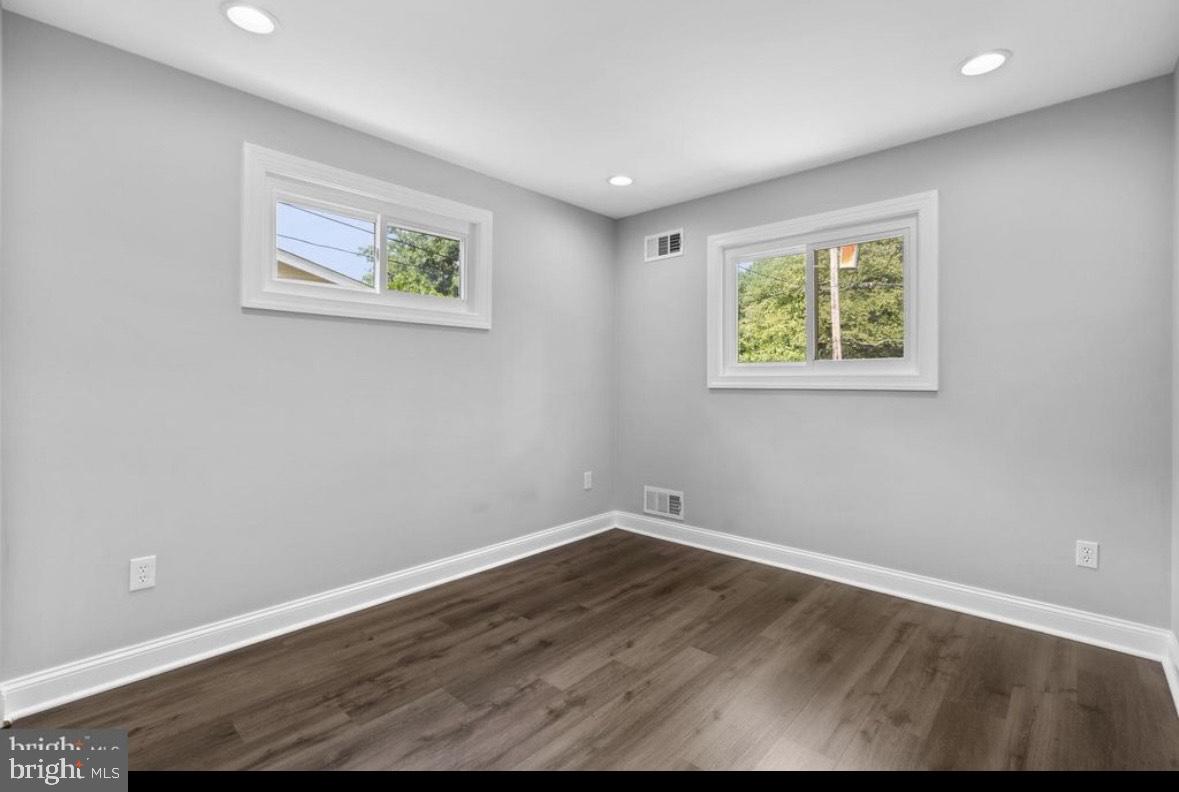 9802 Cherry Tree Lane Silver Spring, MD 20901 - Photo 20 of 33 a view of an empty room with wooden floor and a window