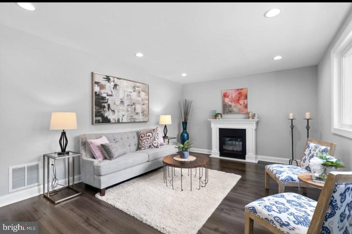 9802 Cherry Tree Lane Silver Spring, MD 20901 - Photo 21 of 33 a living room with furniture a fireplace and a table