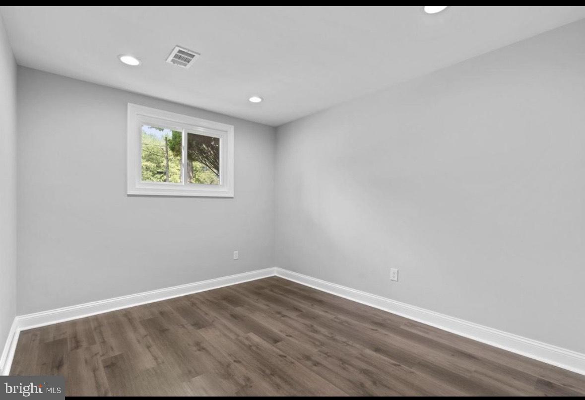 9802 Cherry Tree Lane Silver Spring, MD 20901 - Photo 26 of 33 a view of an empty room with wooden floor and a window