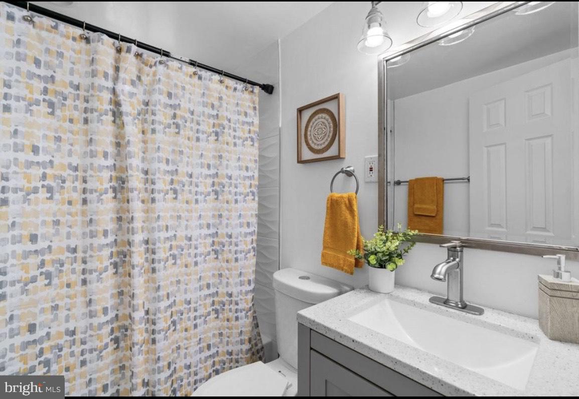 9802 Cherry Tree Lane Silver Spring, MD 20901 - Photo 29 of 33 a bathroom with a sink and a mirror