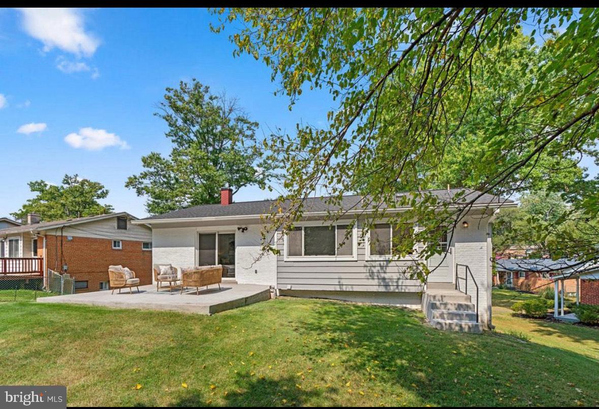 9802 Cherry Tree Lane Silver Spring, MD 20901 - Photo 32 of 33 a front view of a house with swimming pool having outdoor seating
