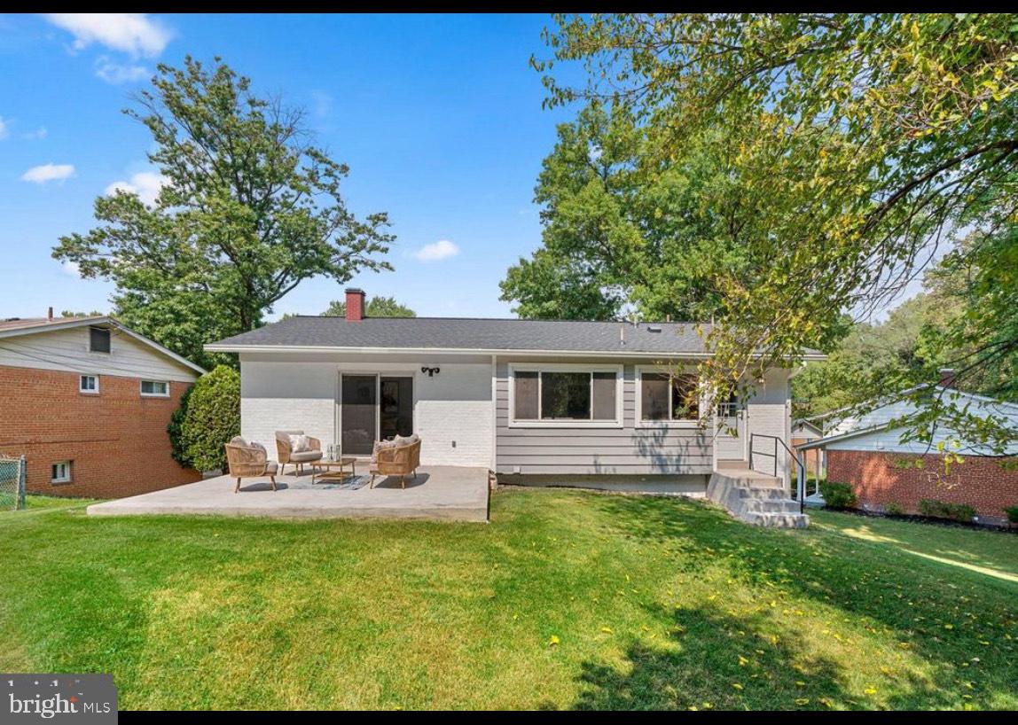 9802 Cherry Tree Lane Silver Spring, MD 20901 - Photo 33 of 33 a view of a backyard with table and chairs potted plants and large tree