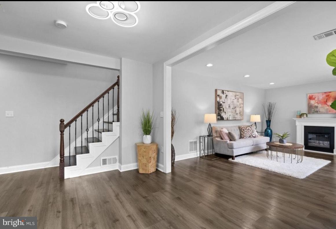 9802 Cherry Tree Lane Silver Spring, MD 20901 - Photo 4 of 33 a living room with fireplace furniture and a wooden floor