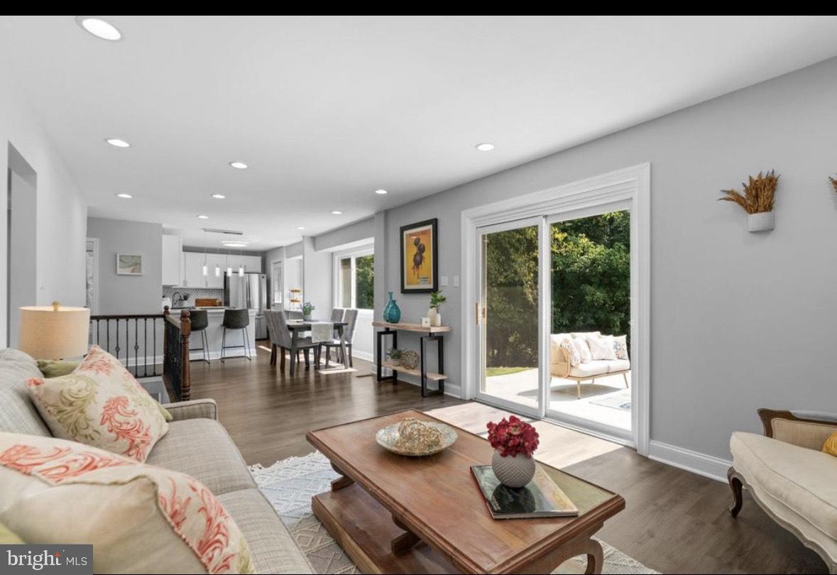 9802 Cherry Tree Lane Silver Spring, MD 20901 - Photo 6 of 33 a living room with furniture and a floor to ceiling window