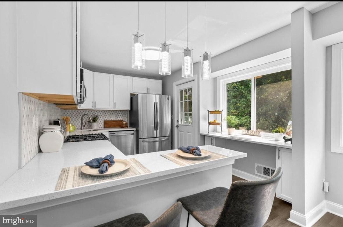 9802 Cherry Tree Lane Silver Spring, MD 20901 - Photo 10 of 33 a kitchen with a sink and appliances