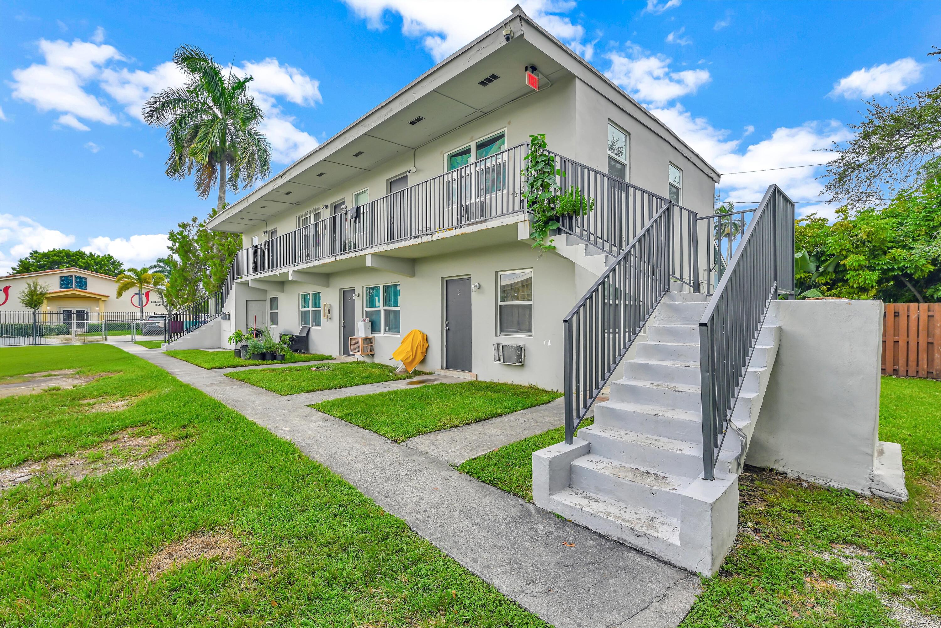 186 Northwest 1st Street Homestead, FL 33030 - Photo 3 of 8 a view of a house with a yard and potted plants