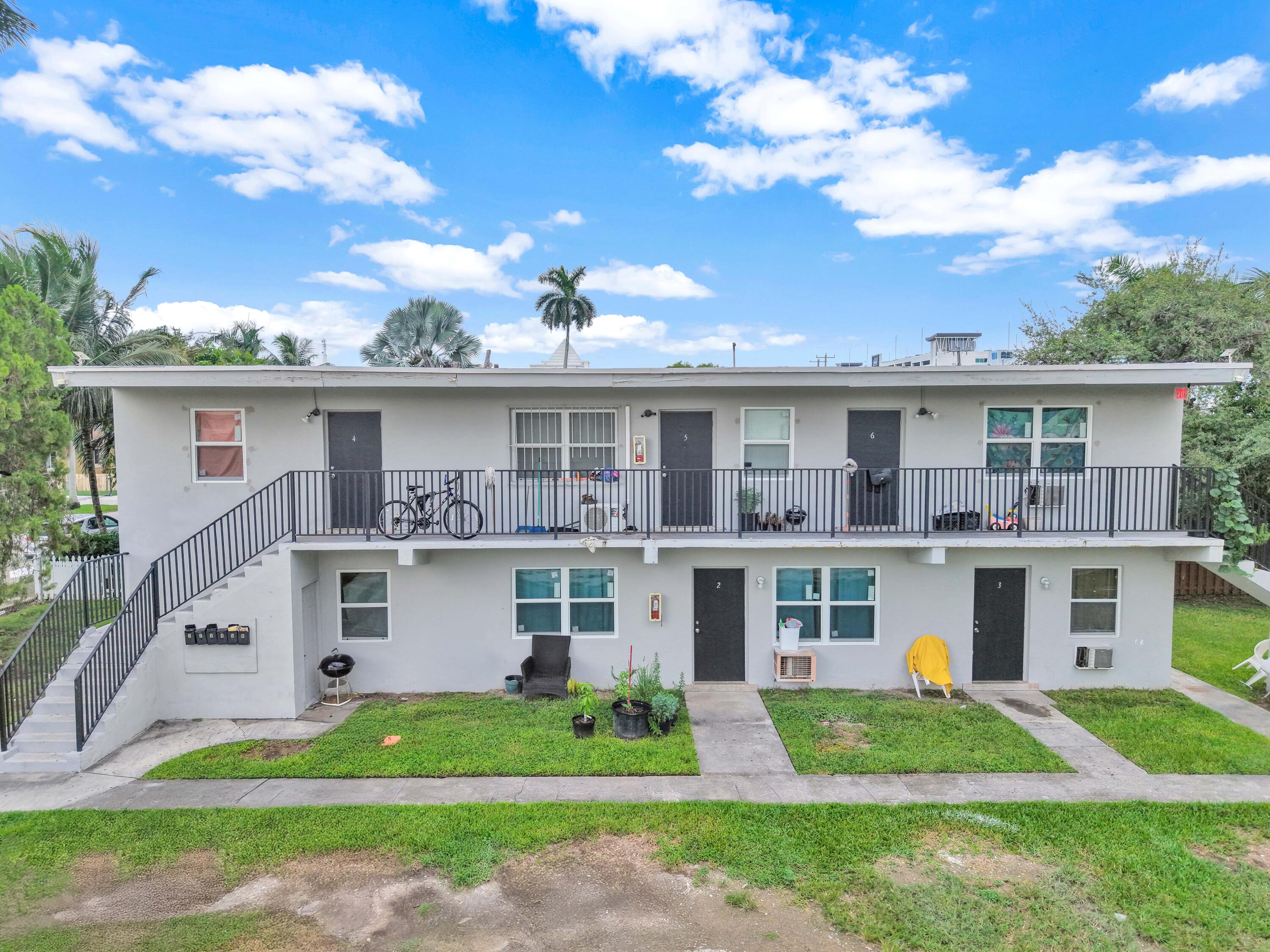 186 Northwest 1st Street Homestead, FL 33030 - Photo 4 of 8 a front view of a house with a yard and potted plants