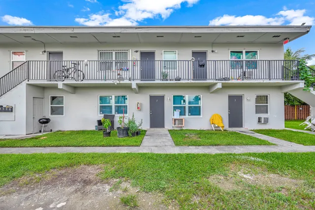 a view of a house with sitting area and garden