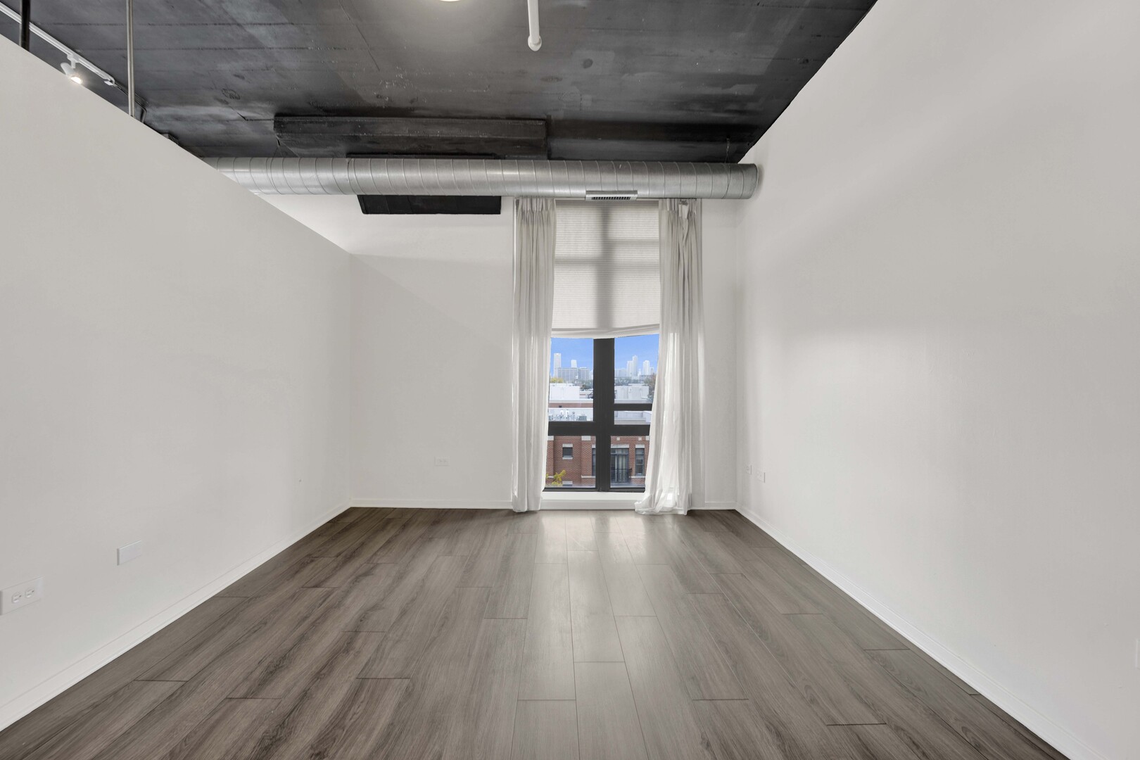 1524 South Sangamon Street, Unit 401 Chicago, IL 60608 - Photo 17 of 55 a view of empty room with wooden floor