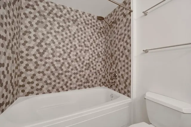 a bathroom with a bathtub and toilet