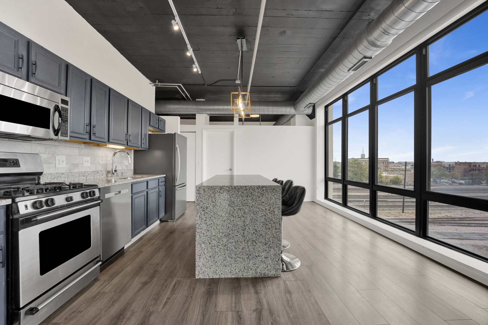 1524 South Sangamon Street, Unit 401 Chicago, IL 60608 - Photo 3 of 55 a kitchen with stainless steel appliances granite countertop a stove a refrigerator a sink and a wooden floors