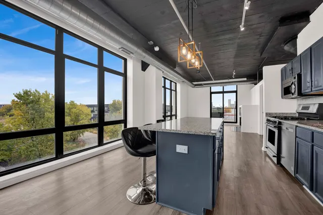 a kitchen with lots of counter top space and stainless steel appliances