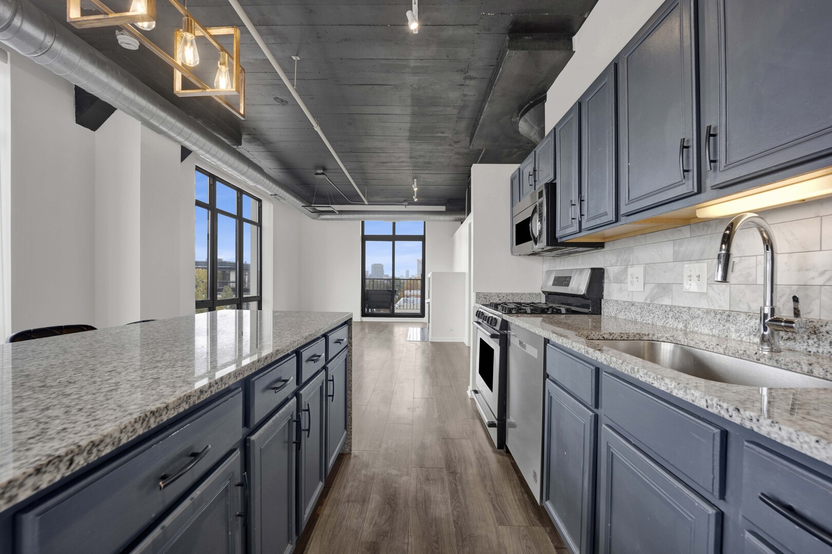 1524 South Sangamon Street, Unit 401 Chicago, IL 60608 - Photo 8 of 55 a kitchen with stainless steel appliances granite countertop a sink a stove top oven a chimney and cabinets
