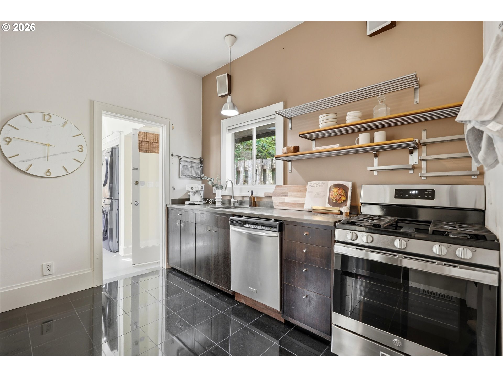 0322 Southwest Whitaker Street Portland, OR 97239 - Photo 14 of 39 a kitchen with stainless steel appliances a stove a sink and a refrigerator