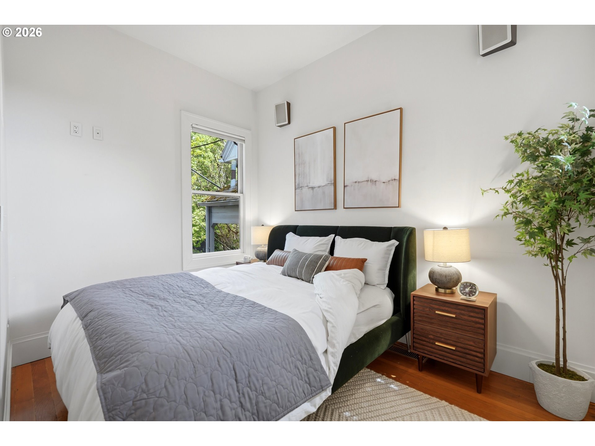 0322 Southwest Whitaker Street Portland, OR 97239 - Photo 21 of 39 a bedroom with a bed and a potted plant