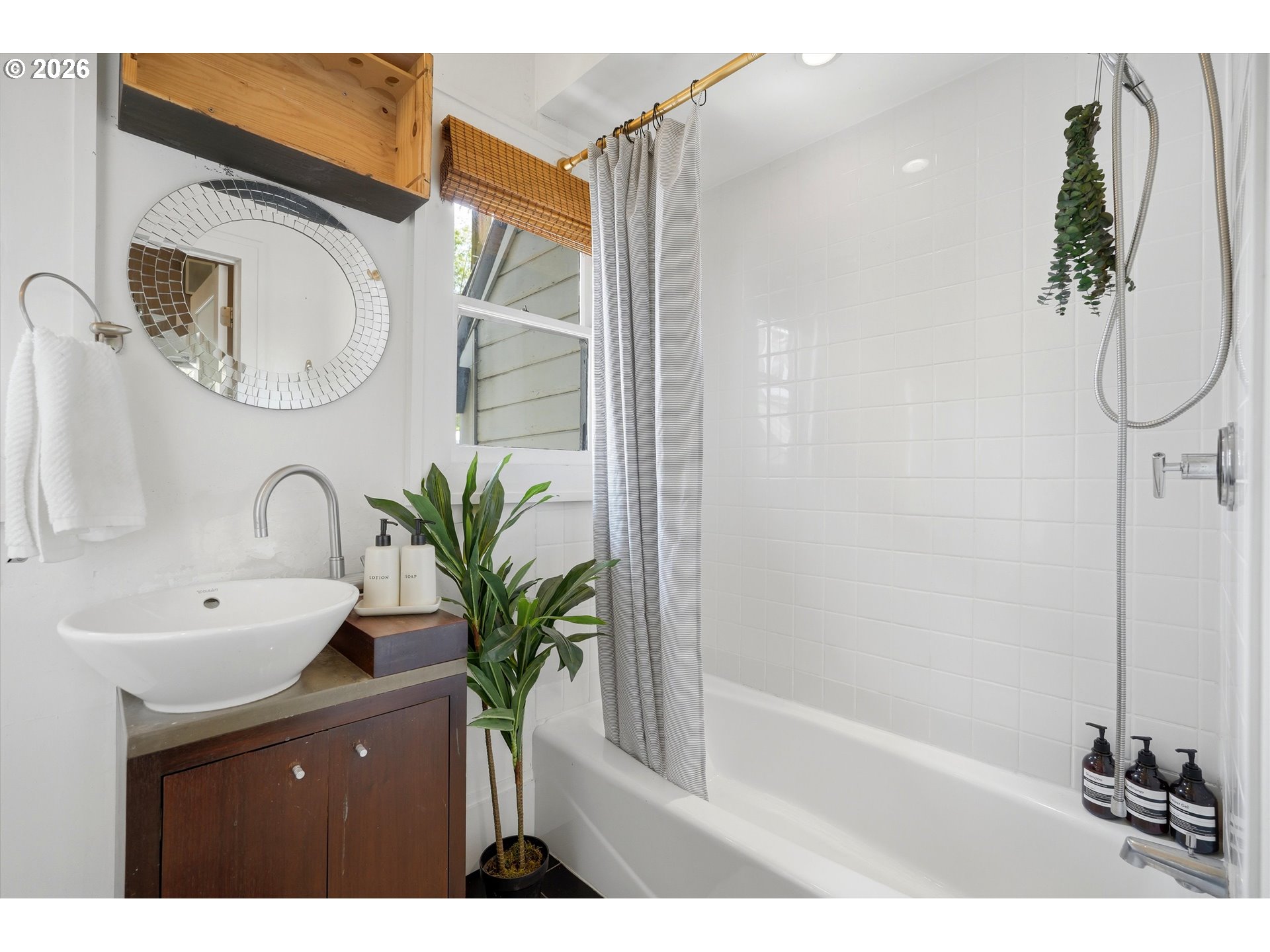 0322 Southwest Whitaker Street Portland, OR 97239 - Photo 23 of 39 a bathroom with a sink a mirror and a bathtub