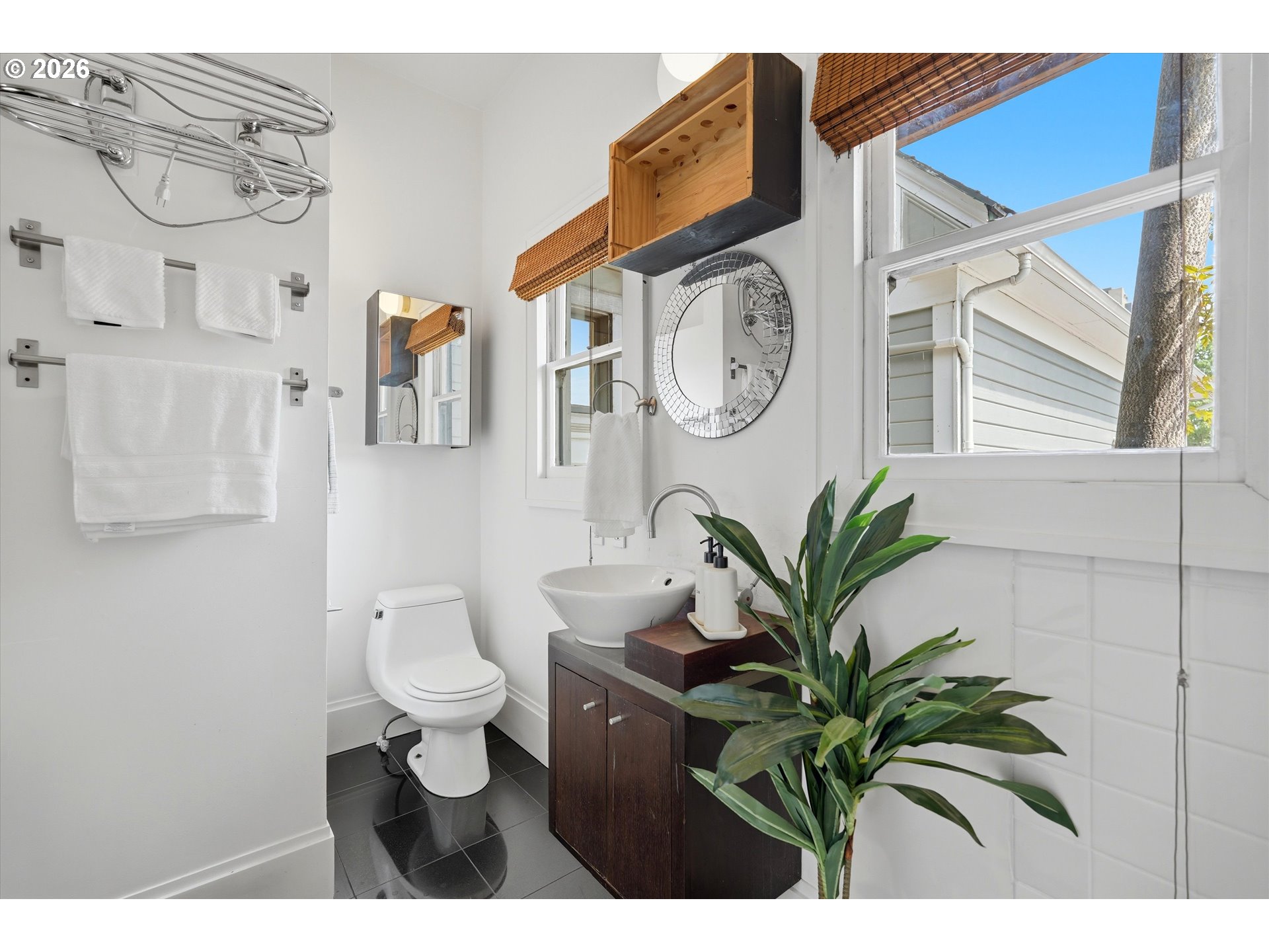 0322 Southwest Whitaker Street Portland, OR 97239 - Photo 24 of 39 a bathroom with a toilet a sink and a mirror
