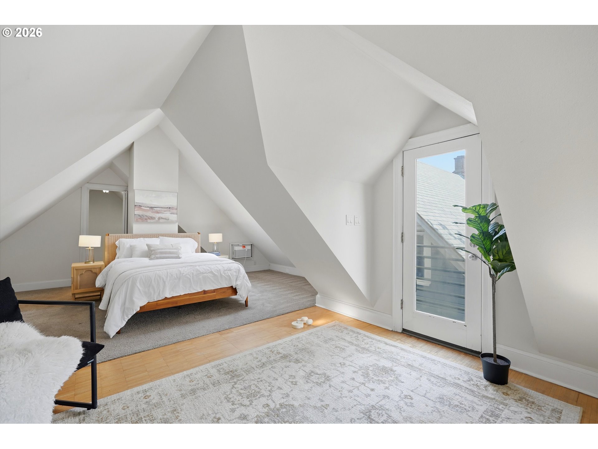 0322 Southwest Whitaker Street Portland, OR 97239 - Photo 25 of 39 a bedroom with a bed and a potted plant