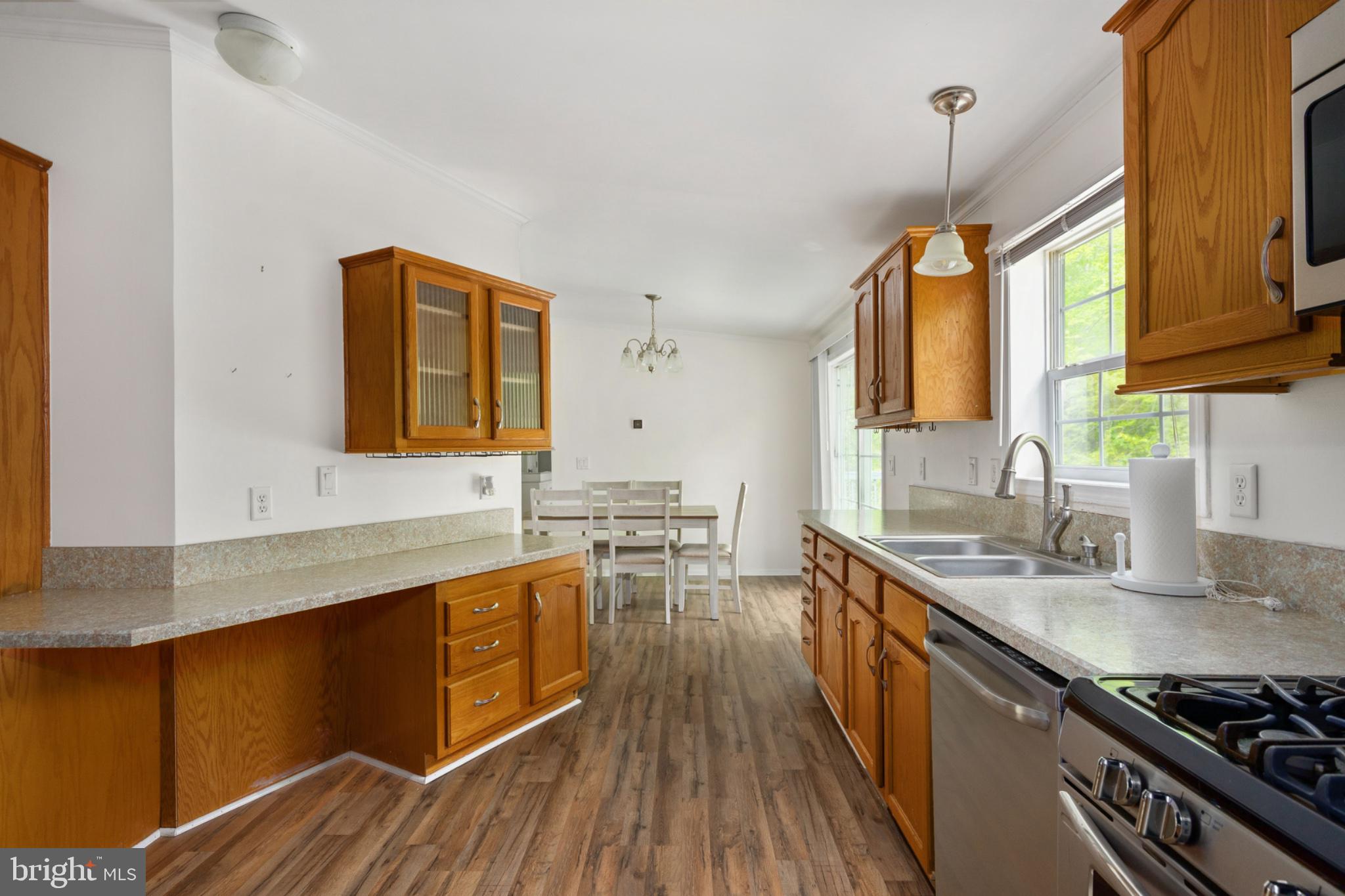 2319 Sizer Road Beaverdam, VA 23015 - Photo 27 of 61 a kitchen with stainless steel appliances granite countertop a sink stove and wooden floor