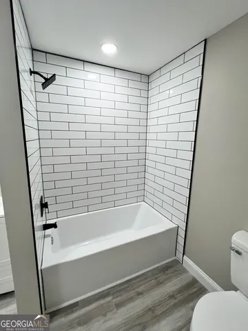 a bathroom with a bathtub and a shower