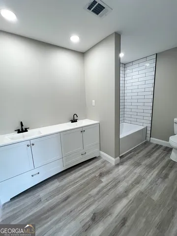 a view of a room with wooden floor