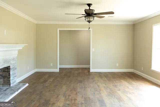 an empty room with a empty space and a ceiling fan