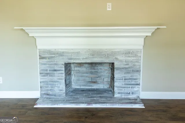 a view of fireplace and wooden floor