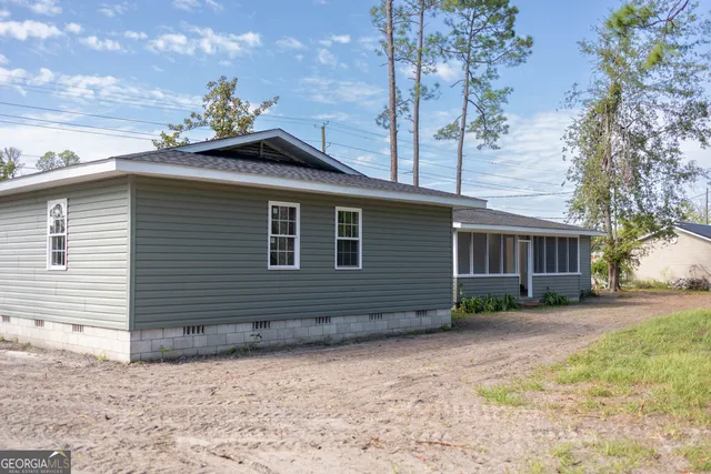 a side view of a house with a yard