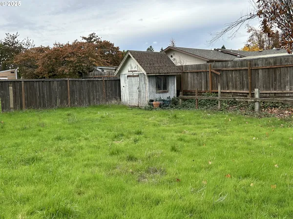 a view of a house with a yard and sitting area