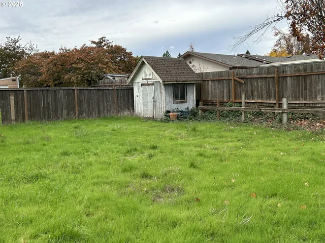 a view of a house with a yard and sitting area