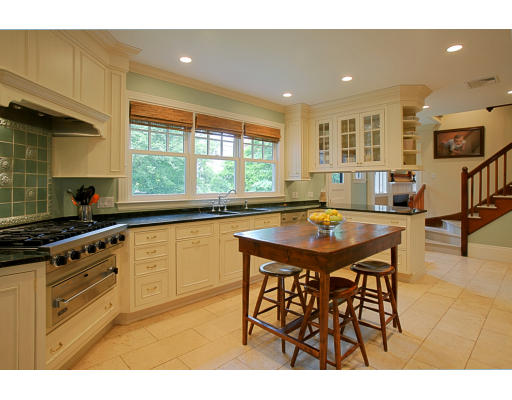 48 Devon Road Brookline, MA 02467 - Photo 1 of 1 a kitchen with stainless steel appliances granite countertop a sink a stove a table and chairs