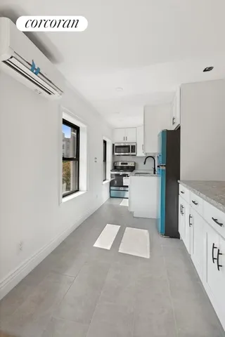 a kitchen with stainless steel appliances a refrigerator and a stove top oven