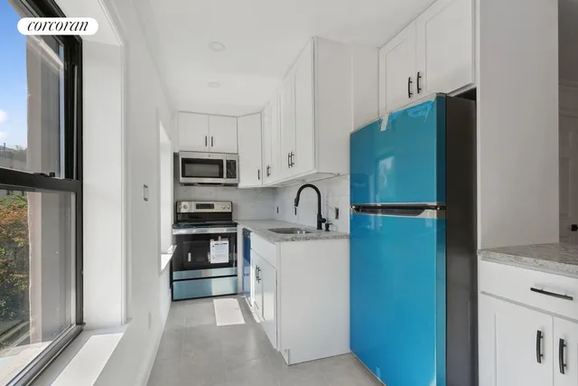 a kitchen with stainless steel appliances granite countertop a refrigerator and a stove