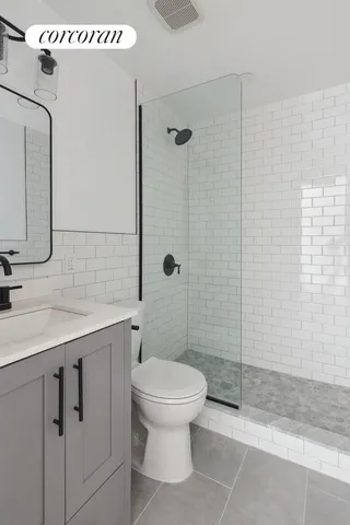 a bathroom with a toilet sink and shower