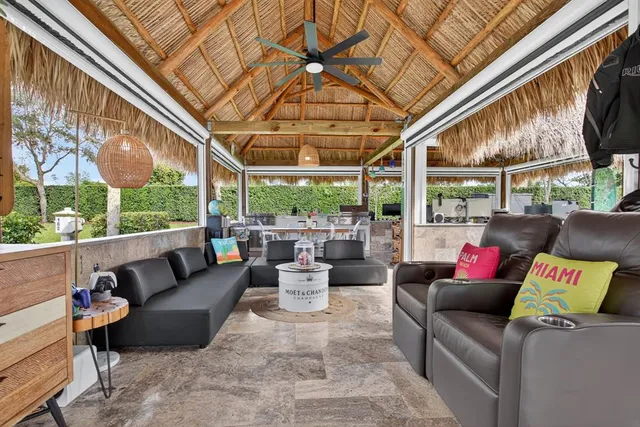 a outdoor living space with patio furniture and a chandelier