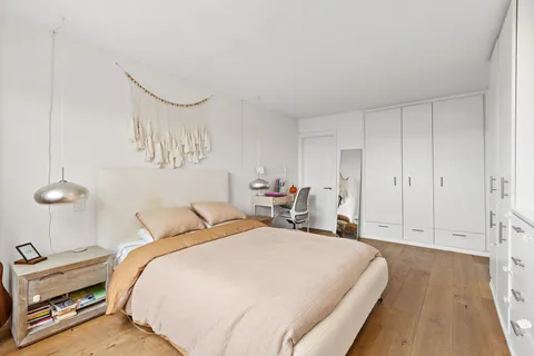 a bedroom with bed and a night stand