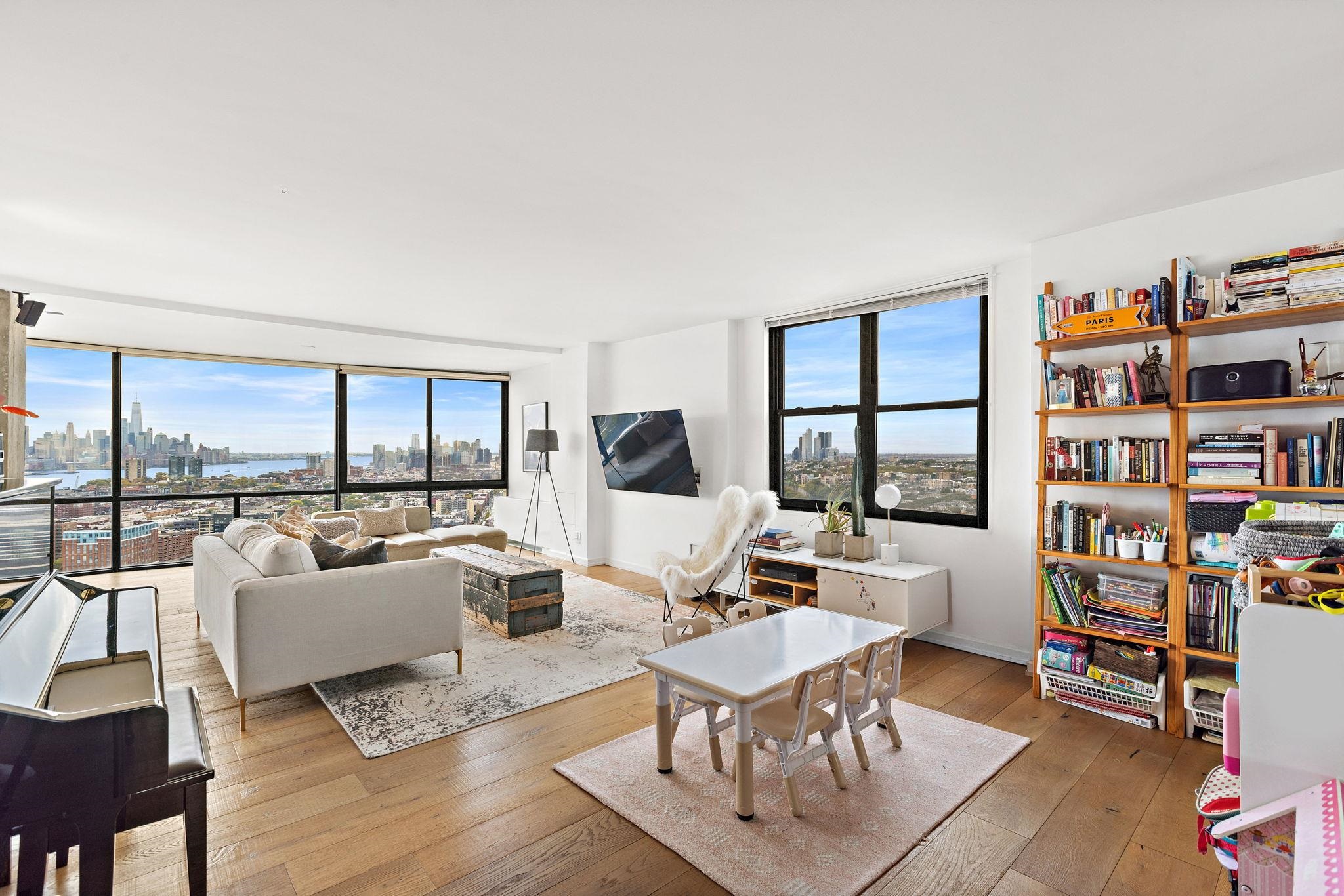 380 Mountain Road, Unit 1813 Union City, NJ 07087 - Photo 2 of 30 a living room with furniture a rug and a book shelf