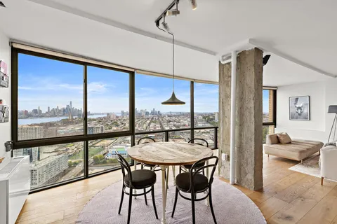 a view of a dining room with furniture window and outside view