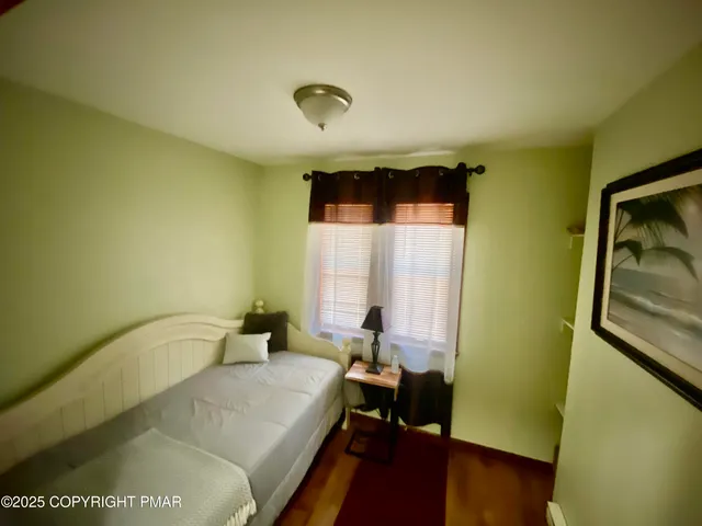 a bedroom with a bed mirror and couch