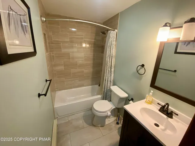 a bedroom with a bed window and a couch